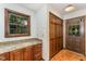 Kitchen area featuring granite counters, wooden cabinets and a door to the outside at 8409 Crowder Rd, Raleigh, NC 27603