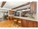 Well-appointed kitchen with wooden cabinets, granite countertops, and a breakfast bar with stools at 8409 Crowder Rd, Raleigh, NC 27603