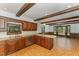 This kitchen features stainless appliances, granite counters, wood beams, and a large window at 8409 Crowder Rd, Raleigh, NC 27603