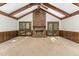 Large living room boasting a brick fireplace, wood beams, and ample natural light at 8409 Crowder Rd, Raleigh, NC 27603