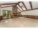 Bright living room featuring vaulted wood beam ceiling and brick fireplace at 8409 Crowder Rd, Raleigh, NC 27603