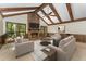 Bright living room featuring vaulted wood beam ceiling, fireplace, and ample seating at 8409 Crowder Rd, Raleigh, NC 27603