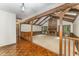 Spacious living room featuring a brick fireplace and striking wood beam architectural details at 8409 Crowder Rd, Raleigh, NC 27603
