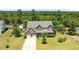 Aerial view of a large home with a well-manicured lawn and surrounded by trees at 870 Kentucky Derby Ln, Lillington, NC 27546