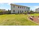 Spacious backyard with a lush lawn, garden beds, patio, and stepping stone walkway at 870 Kentucky Derby Ln, Lillington, NC 27546