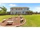 Spacious backyard featuring a stone fire pit, seating, a patio, and garden beds at 870 Kentucky Derby Ln, Lillington, NC 27546
