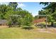 Backyard featuring swing benches hanging from arbor frames and a mature tree at 870 Kentucky Derby Ln, Lillington, NC 27546