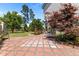 Beautifully designed brick patio area with mature landscaping, creating a perfect outdoor entertaining space at 870 Kentucky Derby Ln, Lillington, NC 27546