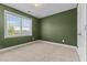 This bedroom features an olive accent wall, carpet, and natural light at 870 Kentucky Derby Ln, Lillington, NC 27546