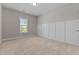Neutral bedroom with carpet flooring, paneled walls, and natural light at 870 Kentucky Derby Ln, Lillington, NC 27546