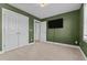 Cozy carpeted bedroom with closet, flat-screen tv and ensuite at 870 Kentucky Derby Ln, Lillington, NC 27546