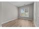 A light and airy bedroom with hardwood floors, white trim and a window with a view of trees at 870 Kentucky Derby Ln, Lillington, NC 27546