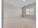 This bedroom features neutral paint, carpet, and natural light at 870 Kentucky Derby Ln, Lillington, NC 27546