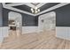 Dining room with wainscoting detail, arched entryway, and luxury vinyl plank flooring at 870 Kentucky Derby Ln, Lillington, NC 27546