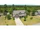 Two-story home with a gray roof, stone accents, a covered porch, an attached two-car garage and driveway at 870 Kentucky Derby Ln, Lillington, NC 27546