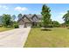 Charming two-story home featuring a stone facade, multi-car garage and a well-manicured lawn at 870 Kentucky Derby Ln, Lillington, NC 27546