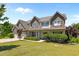 Charming two-story home featuring a stone facade, multi-car garage and a well-manicured lawn at 870 Kentucky Derby Ln, Lillington, NC 27546