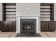 Fireplace with built-in bookcases, logs and mantel at 870 Kentucky Derby Ln, Lillington, NC 27546