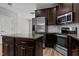 Spacious kitchen with stainless steel appliances, granite countertops, and dark wood cabinets at 870 Kentucky Derby Ln, Lillington, NC 27546