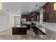 Spacious kitchen featuring dark cabinetry, stainless steel appliances, an island and a eat-in bar at 870 Kentucky Derby Ln, Lillington, NC 27546