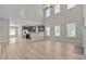 Open floor plan living room with high ceilings, large windows, and luxury vinyl plank flooring at 870 Kentucky Derby Ln, Lillington, NC 27546