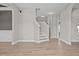 Open-concept living room with hardwood floors and staircase at 870 Kentucky Derby Ln, Lillington, NC 27546