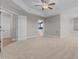 Spacious main bedroom featuring a tray ceiling, ceiling fan, and ensuite bathroom with walk-in shower at 870 Kentucky Derby Ln, Lillington, NC 27546