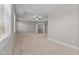 Bright main bedroom offering a ceiling fan, plush carpeting, and an oversized closet with built-in shelving at 870 Kentucky Derby Ln, Lillington, NC 27546