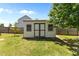 Charming backyard shed with double doors and windows, providing extra storage space and functionality at 870 Kentucky Derby Ln, Lillington, NC 27546