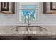 Close-up of a double-basin sink with granite countertop and subway tile backsplash at 870 Kentucky Derby Ln, Lillington, NC 27546