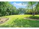 Spacious backyard with a well-maintained lawn, mature trees, and a tranquil setting at 8733 Crowder Rd, Raleigh, NC 27603