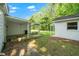 Spacious backyard features a covered patio with a swing and additional storage buildings, perfect for outdoor activities at 8733 Crowder Rd, Raleigh, NC 27603