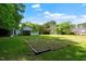 Expansive backyard with plenty of green space, complemented by storage buildings and access to covered parking at 8733 Crowder Rd, Raleigh, NC 27603