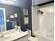 Well-lit bathroom featuring a vanity with sink, toilet, and a separate soaking tub at 8733 Crowder Rd, Raleigh, NC 27603
