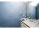 Powder room features textured walls, vanity, and a framed mirror at 8733 Crowder Rd, Raleigh, NC 27603