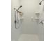 All-white bathroom with multiple shower heads and tiled walls, offering a clean and modern aesthetic at 8733 Crowder Rd, Raleigh, NC 27603