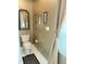 Cozy bathroom with an ornate mirror, decorative art, and natural light from a nearby window at 8733 Crowder Rd, Raleigh, NC 27603