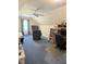 Finished bonus room featuring a ceiling fan, carpet flooring, and a work space at 8733 Crowder Rd, Raleigh, NC 27603
