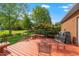 Back deck with patio seating and beautiful views of the lawn and landscaping at 8733 Crowder Rd, Raleigh, NC 27603