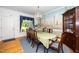 Formal dining room featuring a long table, chandelier, and decorative mural at 8733 Crowder Rd, Raleigh, NC 27603