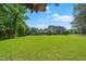 Traditional-style brick house with a green front lawn framed by lush trees, gardens and landscaping at 8733 Crowder Rd, Raleigh, NC 27603