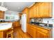 Well-lit kitchen with wood cabinets, granite countertops, and modern appliances at 8733 Crowder Rd, Raleigh, NC 27603