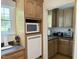 This kitchen area features wood cabinets, countertops, and white appliances at 8733 Crowder Rd, Raleigh, NC 27603