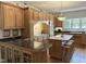 Traditional kitchen with wood cabinets, a center island, and a decorative light fixture at 8733 Crowder Rd, Raleigh, NC 27603