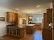 Traditional kitchen features wood cabinets, hardwood flooring, and a center island with bar stool seating at 8733 Crowder Rd, Raleigh, NC 27603