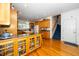 Open-concept kitchen with wood cabinets and hardwood flooring, adjacent to a staircase and entryway at 8733 Crowder Rd, Raleigh, NC 27603