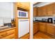 Efficient kitchen space featuring wood cabinets, built-in appliances, and granite countertops at 8733 Crowder Rd, Raleigh, NC 27603