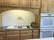 The kitchen features wood cabinets, countertops, tile backsplash, and modern appliances at 8733 Crowder Rd, Raleigh, NC 27603