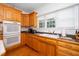 Bright kitchen with wood cabinets, granite countertops, and stainless steel appliances at 8733 Crowder Rd, Raleigh, NC 27603
