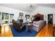 Inviting living room with a fireplace, comfortable seating, and access to an outdoor space at 8733 Crowder Rd, Raleigh, NC 27603